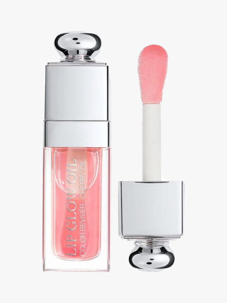 Dior Lip Glow Oil vial of pink lip oil with silver bauble cap and wand to the side on light gray background