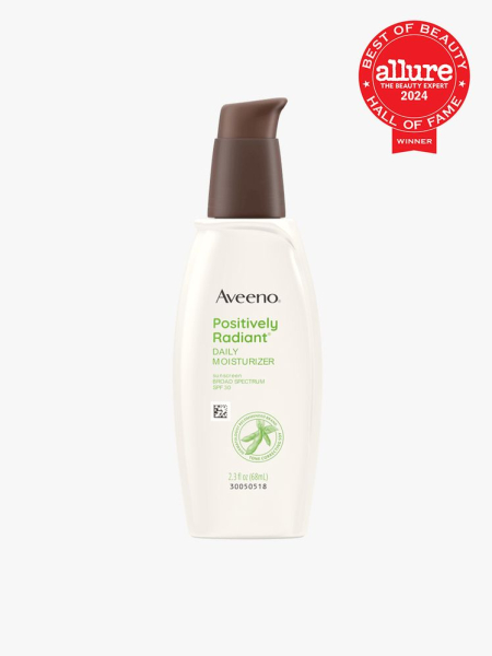 Aveeno Positively Radiant Daily Moisturizer SPF 30 off white bottle of moisturizer with brown pump cap on light gray background with red Allure Best of Beauty seal in the top right corner